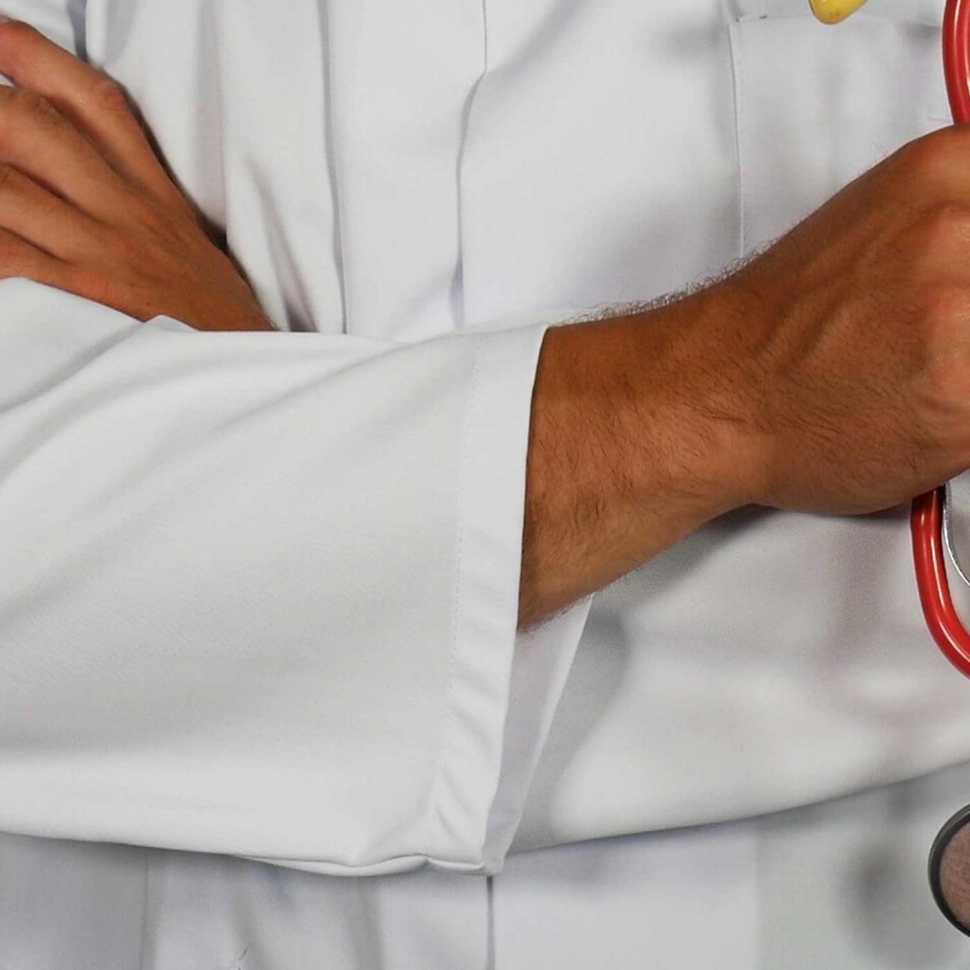 A closeup of a doctor wearing a white jacket and holding a stethoscope.
